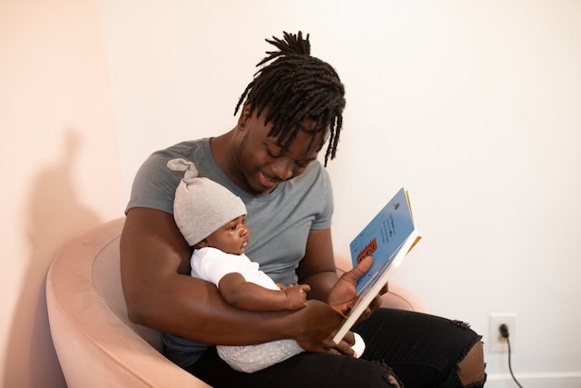 father reading to an infant